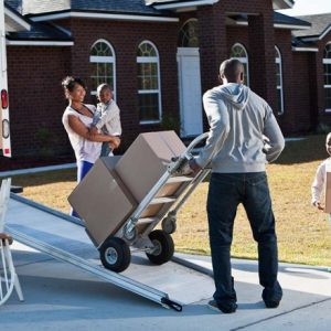 A family loading a moving truck as they move out of their home.