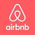 hite Airbnb logo and wordmark on a coral pink background.