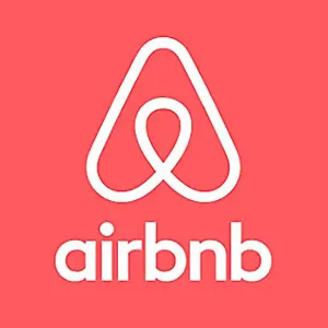 hite Airbnb logo and wordmark on a coral pink background.